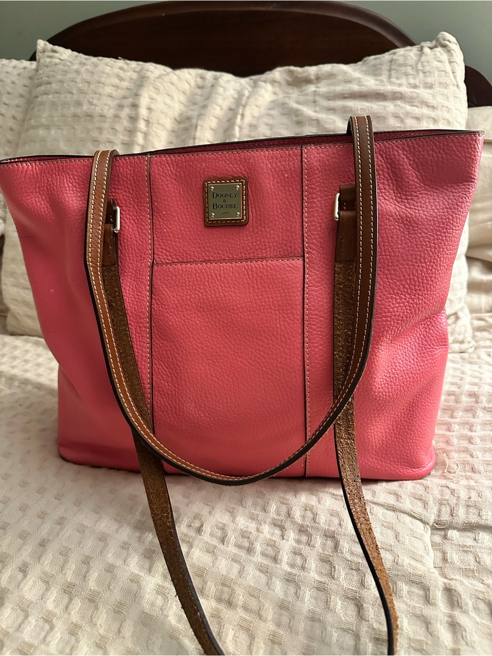 Dooney & Bourke Coral Pink Pebbled Leather Tote with Brown Straps.